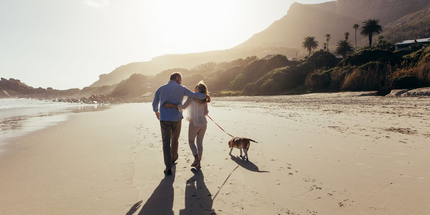 Older couple walking on beach
